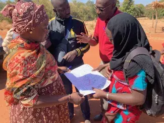 Surveyors identify the boundaries of an enumeration section prior to beginning household surveys during a field pilot, January 2019.